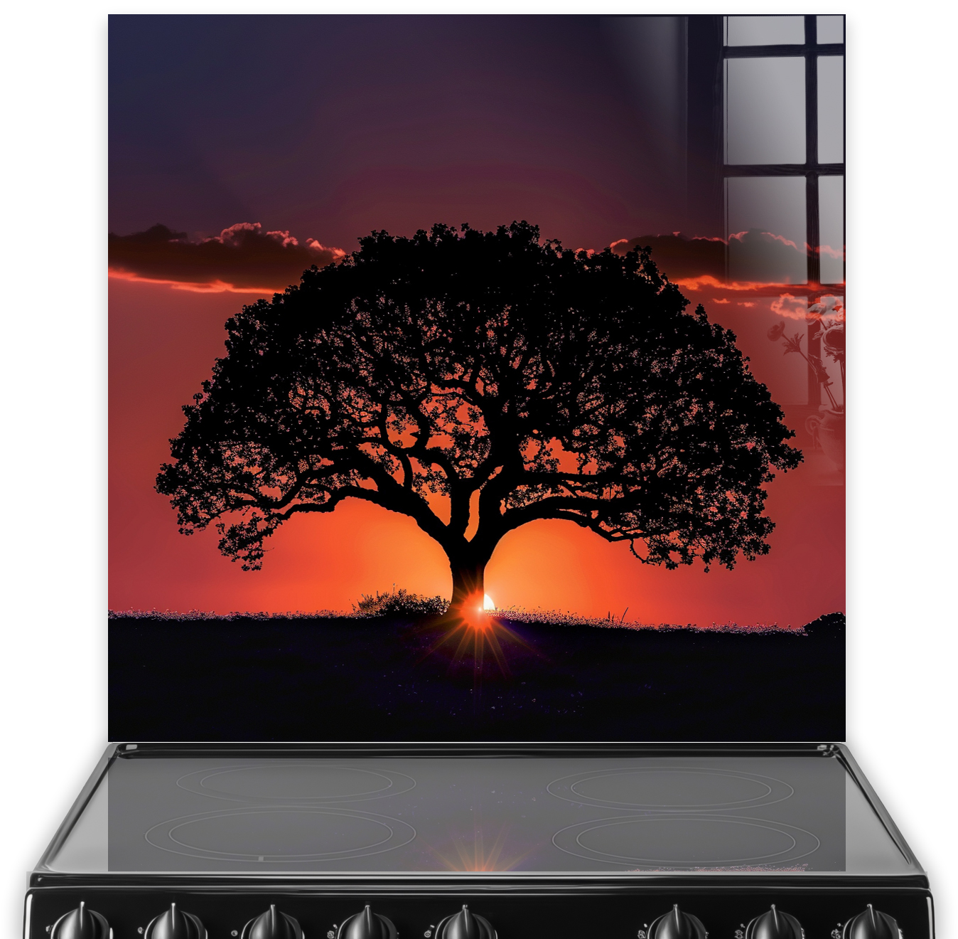 Kitchen with silhouette of a tree against a sunset printed on the splashback, above the stove.