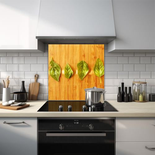 Close-up of four leaves on wooden table glass splashback.