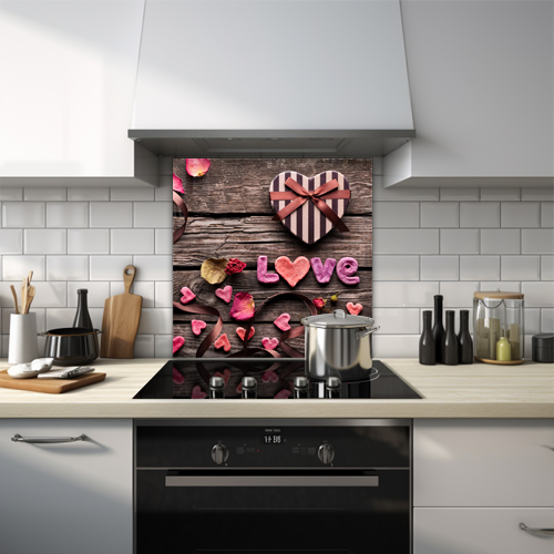 Items spelling 'love' on wooden table glass splashback.