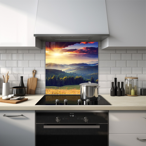 English countryside with green forest, mountain top, and sun shining through clouds glass splashback.