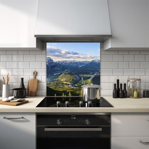Snowy and green mountains with clouds in between glass splashback.
