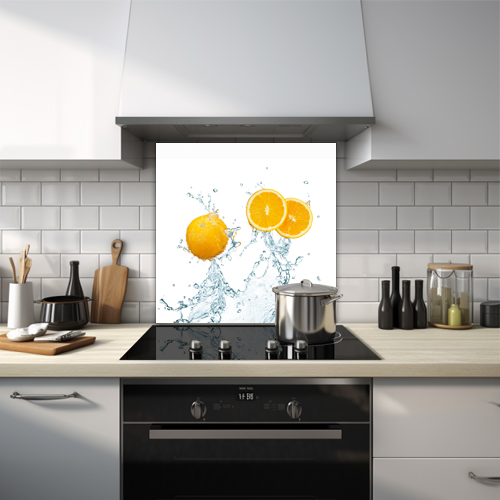 Whole and cut orange in water splash glass splashback.