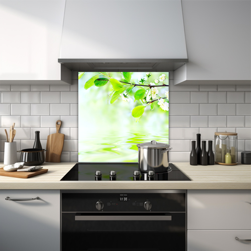 Spring flowers on branch with water reflection glass splashback.
