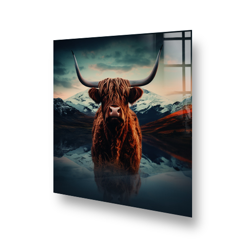 Highland cow with large horns standing before a mountainous landscape and reflected in a calm lake on a kitchen splashback. Side View