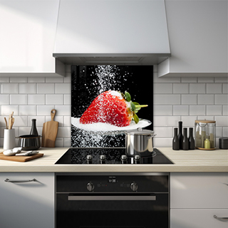 Close-up of a strawberry on a spoon with sugar being poured.