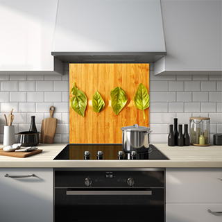 Close-up of four leaves on wooden table glass splashback. thumbnail