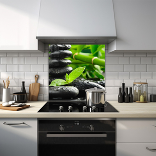 Black stacked pebbles with bamboo background and leaf glass splashback. thumbnail