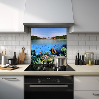 Underwater scene with tropical fish leading to an ocean view with a tropical island glass splashback. thumbnail