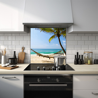 Hammock attached to a palm tree with ocean in the background on a tropical island glass splashback. thumbnail