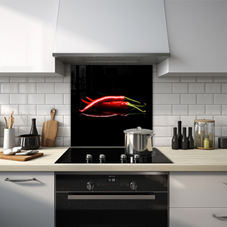 Glass splashback of three red chillies against a black background. thumbnail
